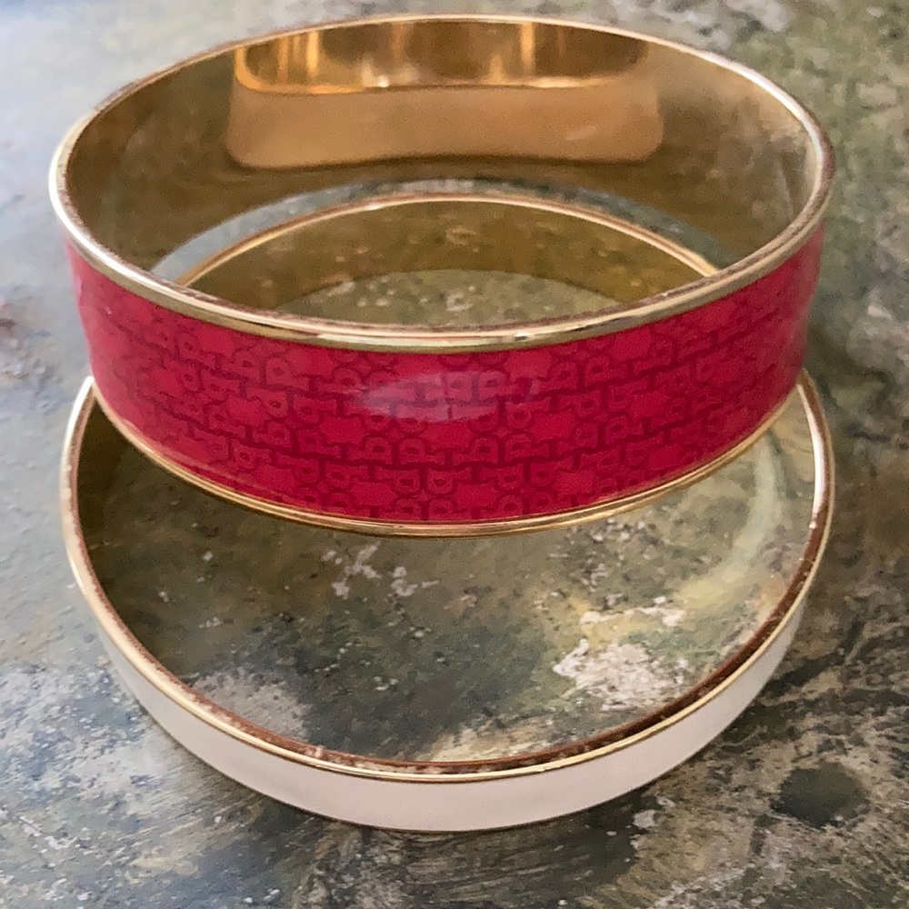 Two enamel gold toned bangles pink and white